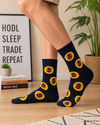 Black crew socks featuring colorful Bitcoin cryptocurrency coin patterns in a fun novelty design