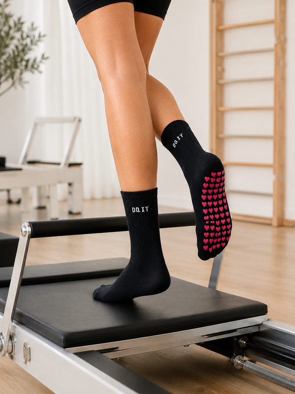 Black Do It Non-Slip Grip Socks featuring white DO IT embroidery and pink heart-shaped anti-slip grips on the sole.