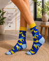 Model wearing blue banana pattern socks in a colorful lifestyle setti