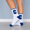 White crew socks with blue C letter design, blue cuff, heel and toe