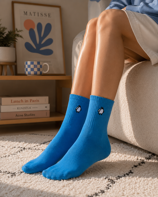 Blue crew socks with minimalist penguin embroidery design