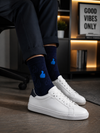 Blue crew socks with bright thumbs up icon pattern displayed on a lifestyle product image.