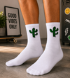 Crew socks featuring a cute cactus playing tennis with a racket on a sporty themed design.