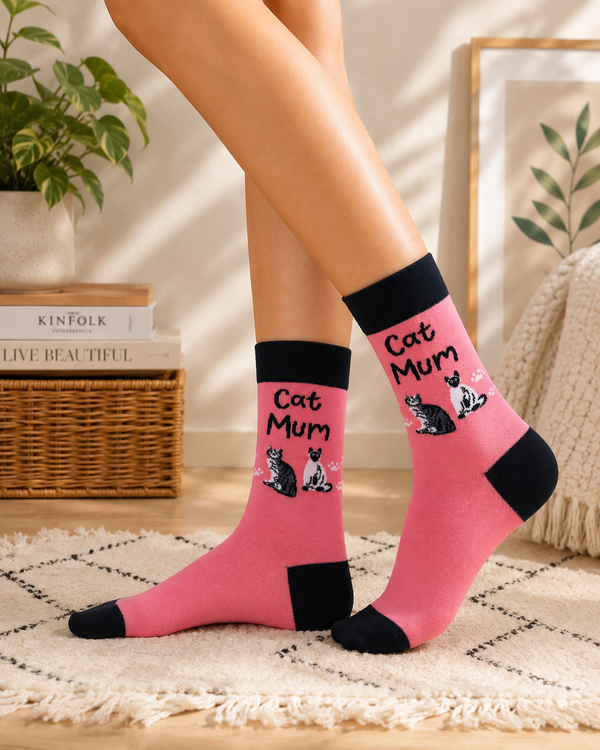Pink crew socks featuring Cat Mum text with cute cat illustrations and playful aesthetic design.