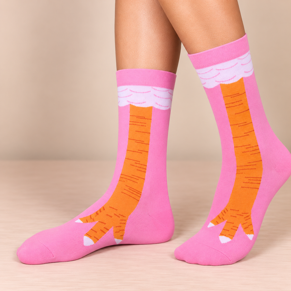 Pink crew socks featuring a funny orange chicken leg design