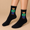 Black crew socks with teddy bear wearing green sweater and blue jeans