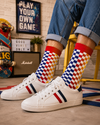 Colorful checkerboard crew socks in blue red yellow and white geometric block pattern