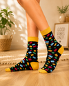 Black crew socks with colorful building block pattern and yellow cuff, heel and toe