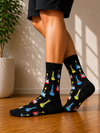 Black crew socks featuring colorful electric guitar illustrations in red, blue, yellow, and white.