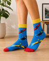 Bright blue crew socks featuring colorful kayaks and paddlers with yellow cuffs and red toes