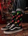 Black crew socks featuring colorful tongue and lips graphics in a bold retro rock-inspired pop art design with green and blue accents.
