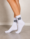 White crew socks featuring black Crazy Bitch statement text