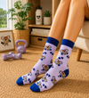 Pastel purple crew socks with cute koala lifting dumbbells pattern and blue cuffs