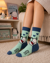 Mint green crew socks featuring cute Pochacco cartoon artwork with blue hearts and pastel aesthetic design