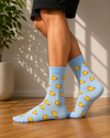 Light blue crew socks featuring an all-over pattern of yellow rubber ducks.