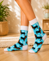 Turquoise crew socks with black and brown dachshund dogs, white paw prints and white accents