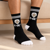 Black crew socks with Einstein character, E=MC² equation, white stripes, toe and heel