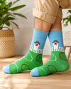 Green and blue crew socks featuring a cartoon duck wearing a farmer hat standing behind a white fence on a grassy field design.