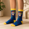 Blue crew socks with Frida-inspired sugar skull portrait, red roses and yellow cuffs, heels and toes