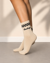 Beige crew socks with black checkerboard pattern and Goose Hunger text