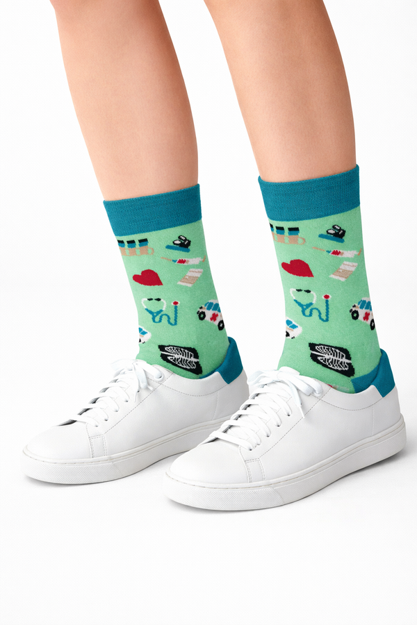 Pair of mint green crew socks with medical doctor icons and teal cuff, heel, and toe on a white background.