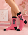 Pink crew socks featuring grumpy cat graphic with bold funny statement text design.