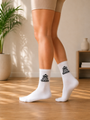 White crew socks with yellow smiley face and drew graphic design