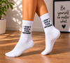 White crew socks with the phrase "I Don't Give A F*ck Anymore" in black lettering.