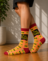 Peach-colored crew socks featuring emoji faces and the text "I'm Moody" with red heel, toe, and cuff accents.