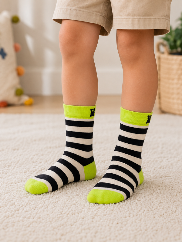 Kids crew socks with black and white stripes, neon green cuffs, heels, and toes, designed for children aged 3–5 years.