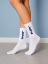 White crew socks with navy blue LOVE text arranged vertically