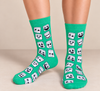 Green crew socks featuring playful white marshmallow faces with different black facial expressions.