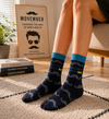 Dark navy crew socks with mustache pattern and Movember themed text design.