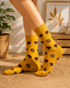 Mustard yellow crew socks featuring cute brown mushroom pattern designs with playful aesthetic style.