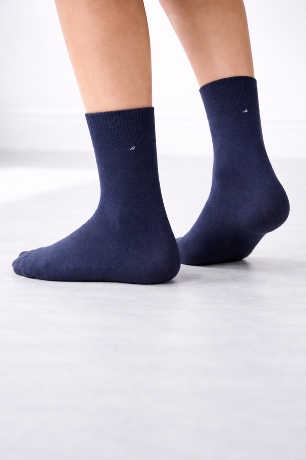 Pair of navy blue plain crew socks with minimal stitch detail on a clean white background