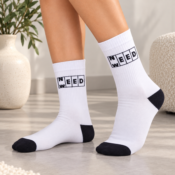 White crew socks with black Need Weed graphic and contrasting black toe and heel