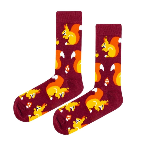  Nutty Squirrel Socks! These rich burgundy socks feature adorable orange squirrels snacking on acorns, surrounded by tiny mushrooms – the perfect cozy woodland vibe.
