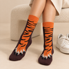 Orange and dark brown crew socks featuring striped tiger legs and clawed tiger paws