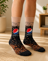 Pair of black and beige Pepsi Cola Bubble Crew Socks featuring the classic Pepsi logo with a bubbly cola splash design on a white background.