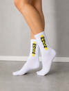White crew socks with black Physical text over a yellow vertical stripe