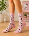 Pink crew socks featuring an all-over Hello Kitty character pattern with red bows