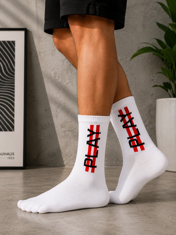 White crew socks featuring a bold vertical PLAY graphic with red accents.