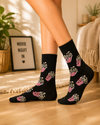 Black crew socks featuring red and white striped popcorn boxes with yellow popcorn