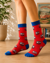 Red crew socks featuring repeating red and white retro camper vans with royal blue cuffs and toes