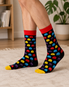 Black socks with colorful retro pixel ghost characters in red, blue, yellow, and purple with red cuff and yellow toe.