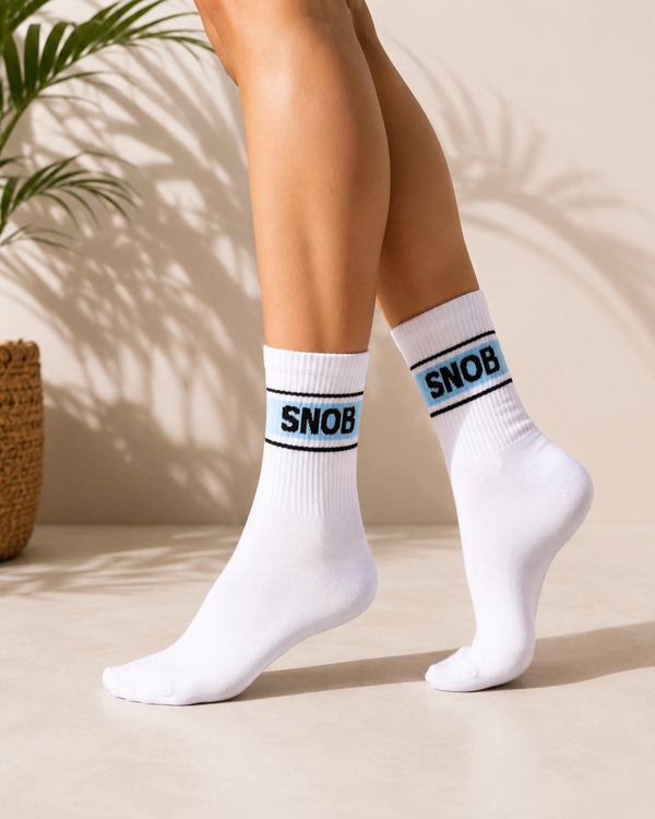 White crew socks featuring a blue band with bold black SNOB text.