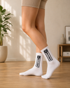 White crew socks with black slide to unlock graphic design