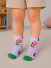 Light purple kids crew socks with a smiling flower design and green toe for toddlers aged 2–3 years.