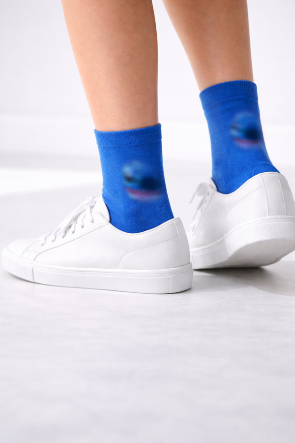 Blue cartoon character crew socks with smiling alien-inspired face design