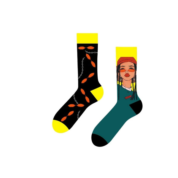 Street Vibes Socks – Chains &amp; Shades Edition. One sock features an edgy black-and-yellow pattern with orange links and chain graphics, while the other rocks a bold illustration of a street-style girl in braids, sunglasses, and a red cap